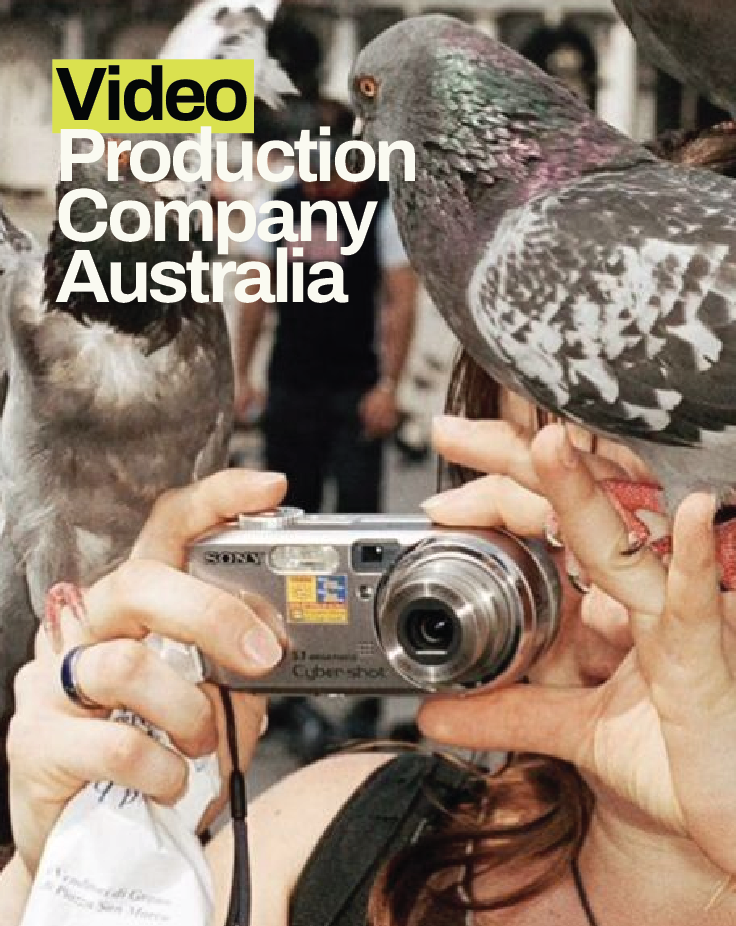 Editorial image representing video production in Australia, capturing authentic storytelling through a camera surrounded by pigeons in an urban setting.
