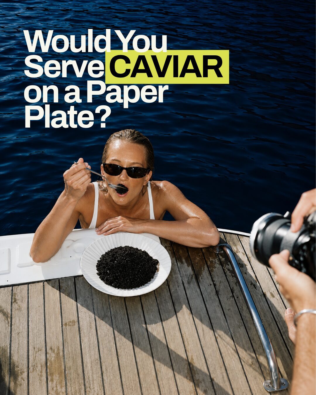 Woman eating caviar off a paper plate on a yacht deck during a MOK'HOUSE creative shoot